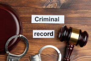 criminal record written on the table with Handcuff and gavel