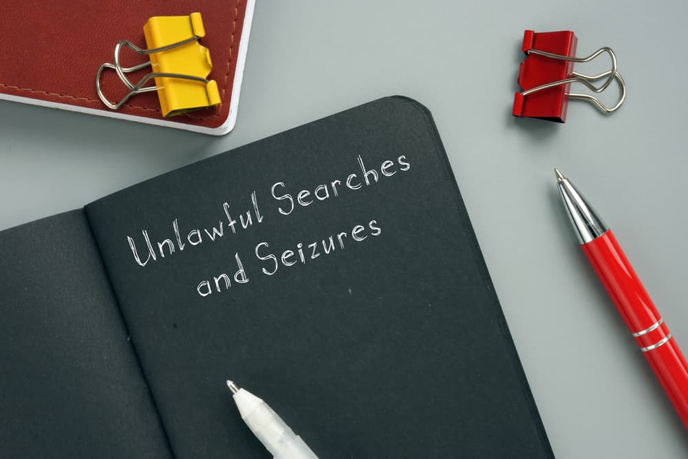 Unlawful Searches and Seizures sign on the page.