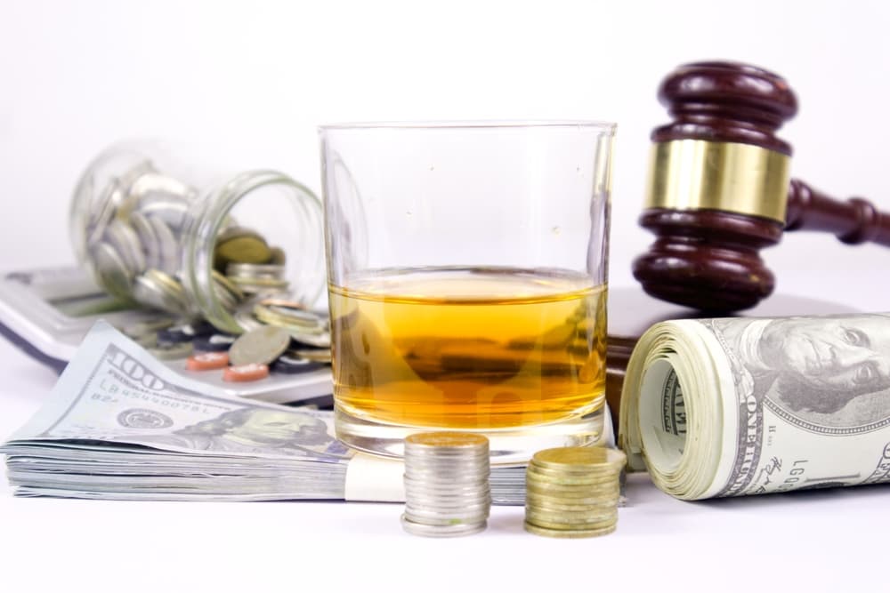 Judge hammer, dollar amount and whiskey glass, car key.